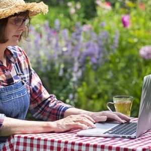 Woman On Laptop In Garden